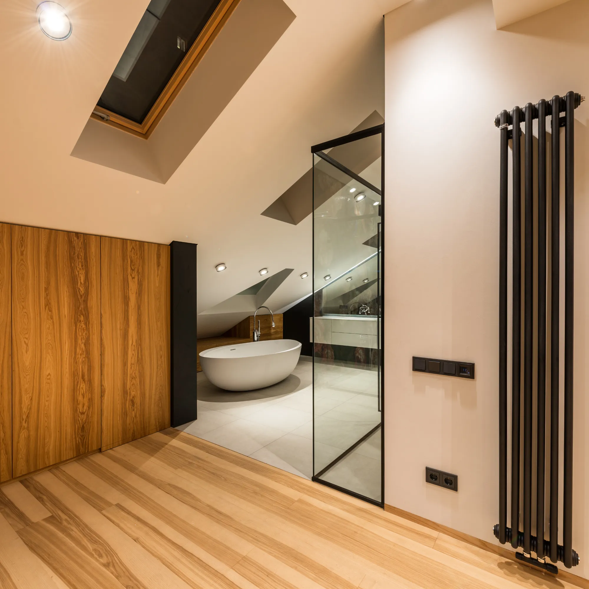 Modern bathroom featuring a freestanding bathtub and glass shower enclosure