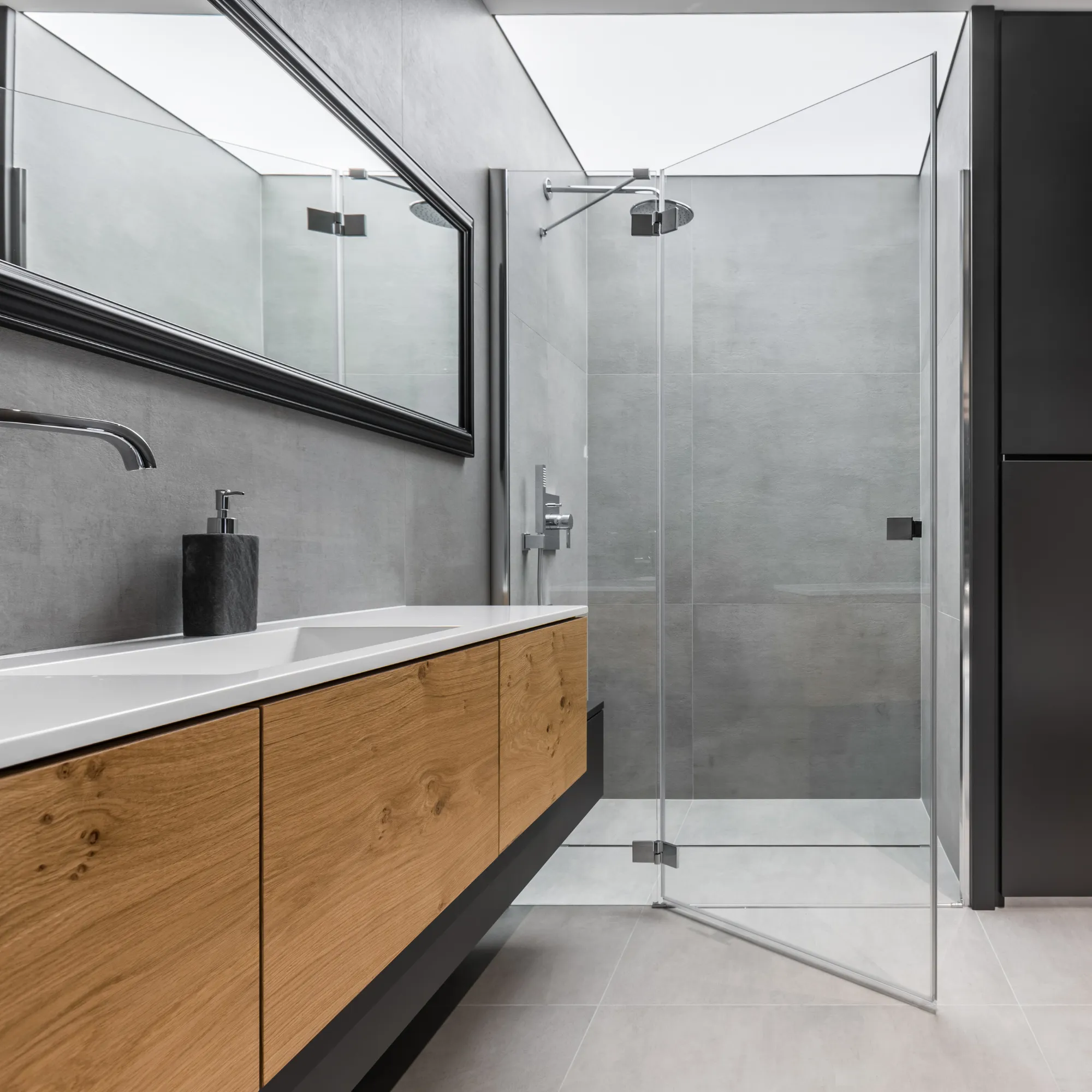 Modern bathroom featuring a glass shower, wooden vanity, and sleek gray walls, an example of Crestmark's premium craftsmanship.